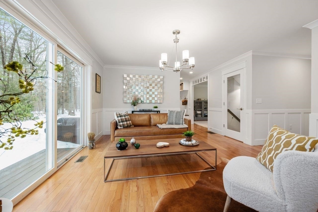 367 Powder Mill Road Concord, MA 01742 - Photo 11 of 42 a living room with furniture and a chandelier