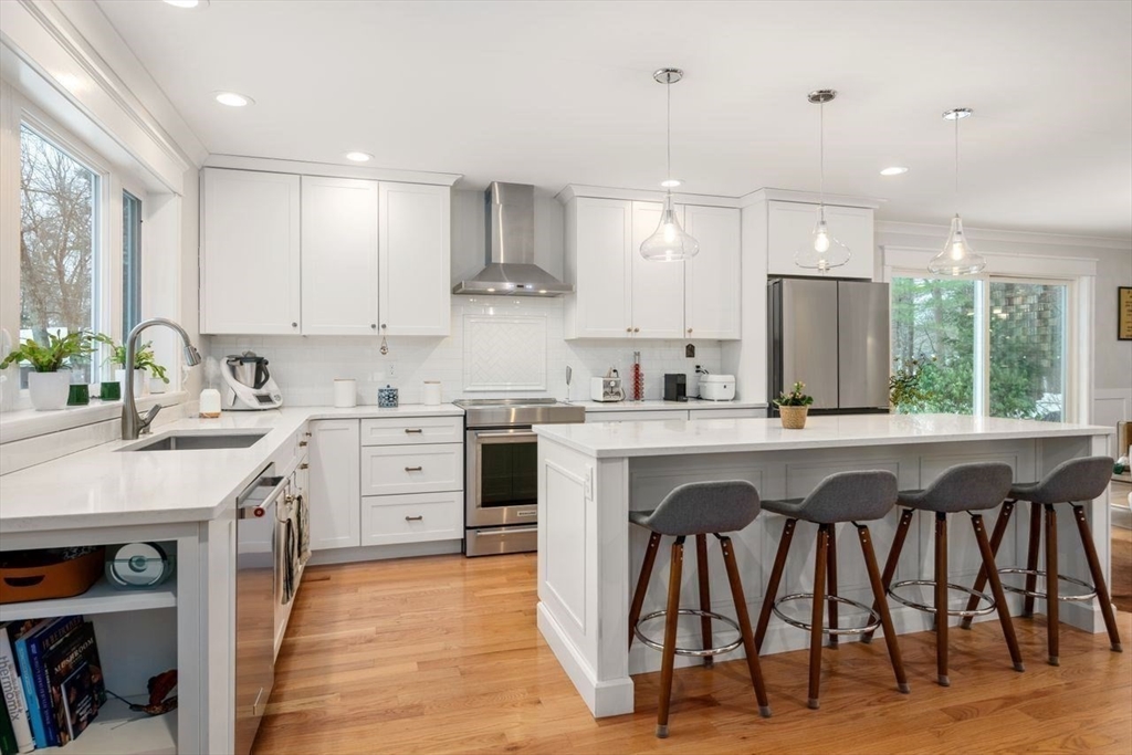 367 Powder Mill Road Concord, MA 01742 - Photo 15 of 42 a kitchen with a table chairs sink and cabinets