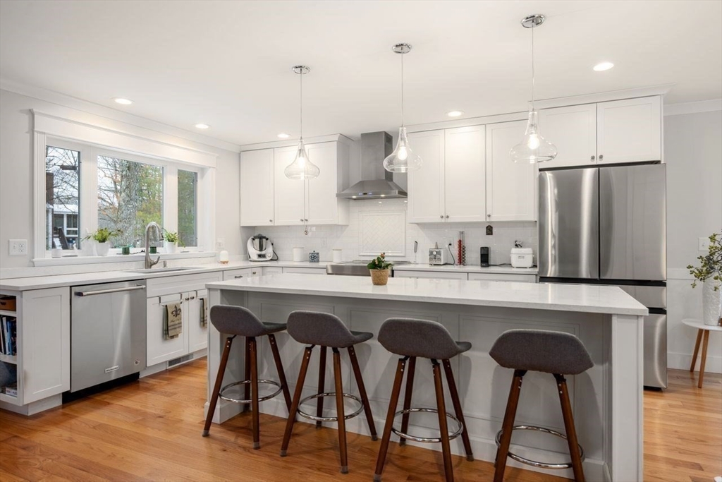 367 Powder Mill Road Concord, MA 01742 - Photo 16 of 42 a kitchen with stainless steel appliances a table chairs refrigerator and sink