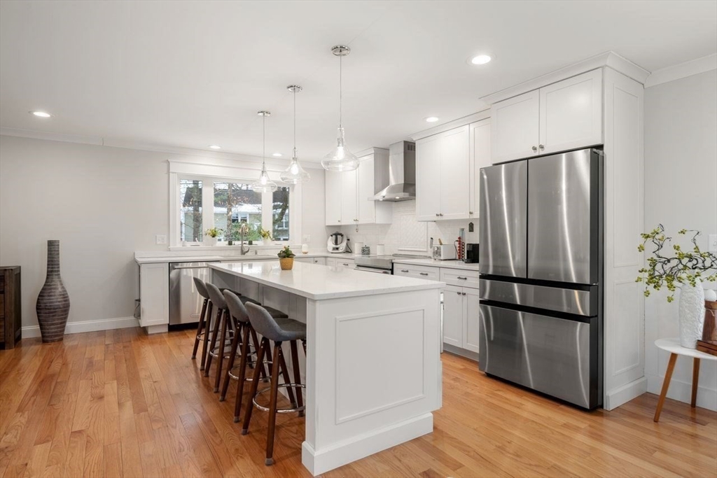 367 Powder Mill Road Concord, MA 01742 - Photo 17 of 42 a kitchen with kitchen island white cabinets and stainless steel appliances
