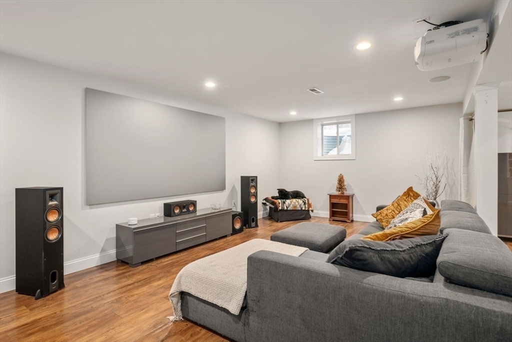 367 Powder Mill Road Concord, MA 01742 - Photo 23 of 42 a living room with furniture and a flat screen tv
