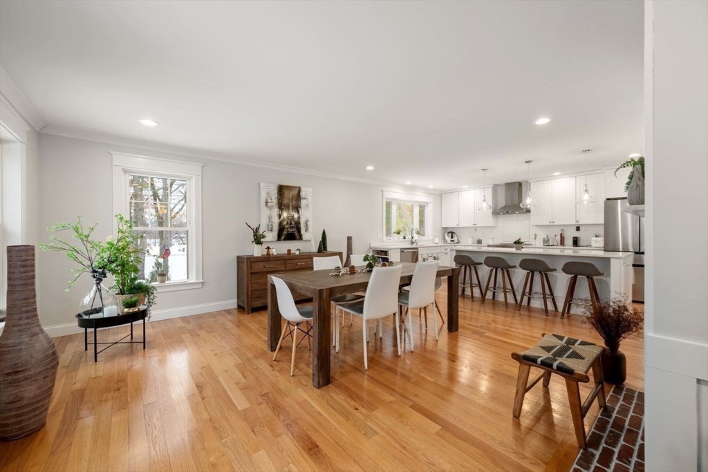 367 Powder Mill Road Concord, MA 01742 - Photo 27 of 42 a living room with furniture dining table a wooden floor and a window