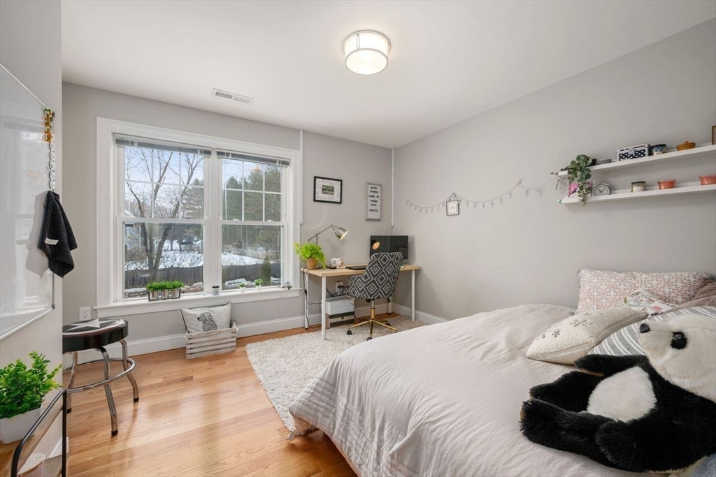 367 Powder Mill Road Concord, MA 01742 - Photo 28 of 42 a bedroom with a bed and large windows
