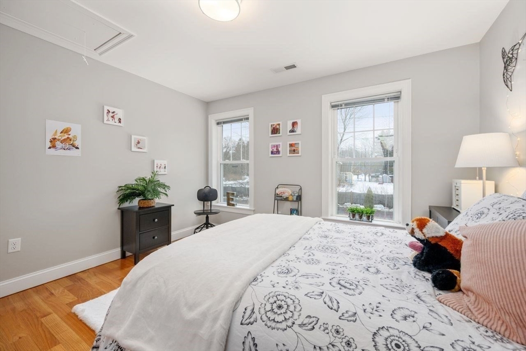 367 Powder Mill Road Concord, MA 01742 - Photo 32 of 42 a bedroom with a bed table and a window