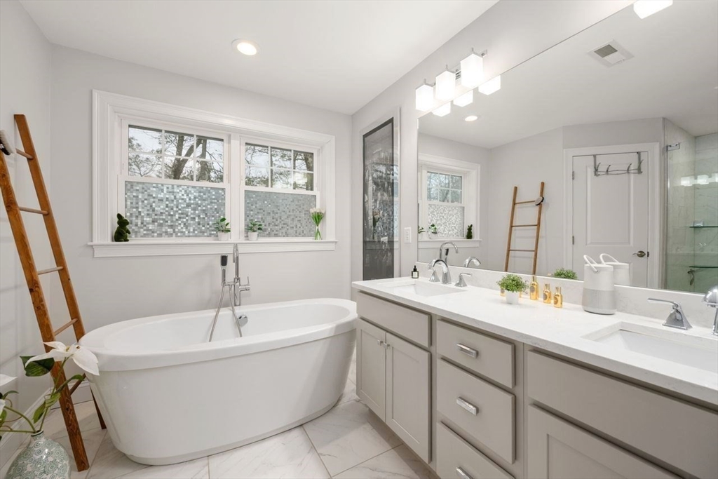 367 Powder Mill Road Concord, MA 01742 - Photo 36 of 42 a bathroom with a tub sink and mirror