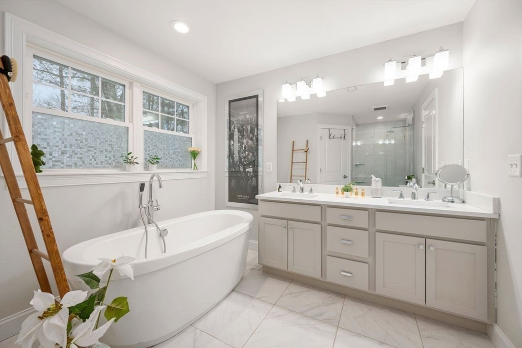 367 Powder Mill Road Concord, MA 01742 - Photo 37 of 42 a bathroom with a tub sink shower and mirror