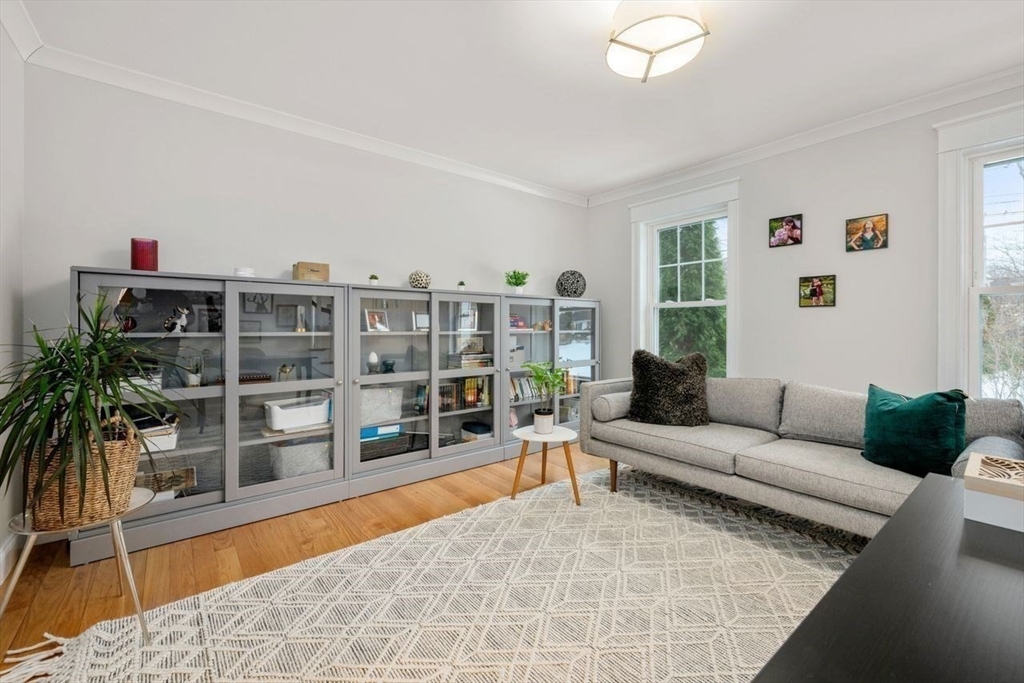 367 Powder Mill Road Concord, MA 01742 - Photo 7 of 42 a living room with furniture and a book shelf