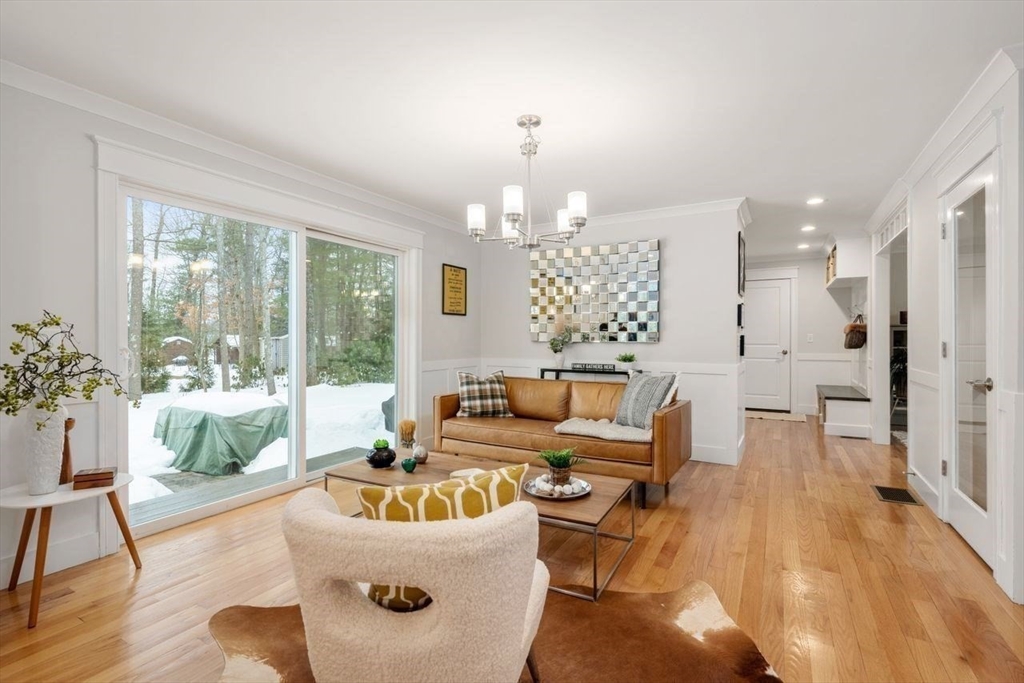 367 Powder Mill Road Concord, MA 01742 - Photo 10 of 42 a living room with furniture and a chandelier