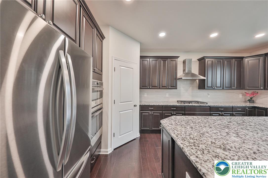 338 Abby Road Macungie, PA 18062 - Photo 11 of 40 a kitchen with stainless steel appliances granite countertop a refrigerator a stove and a sink