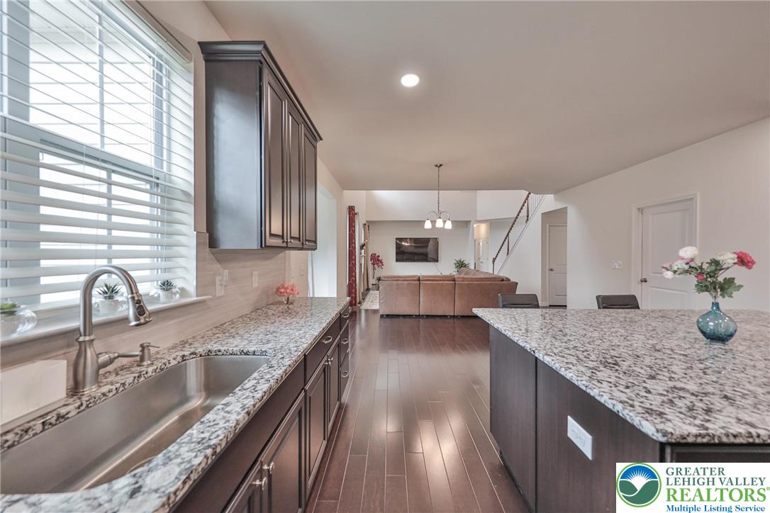 338 Abby Road Macungie, PA 18062 - Photo 16 of 40 a kitchen with granite countertop kitchen island stainless steel appliances a sink stove and cabinets