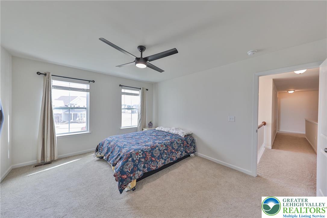 338 Abby Road Macungie, PA 18062 - Photo 31 of 40 a spacious bedroom with a bed and a large window