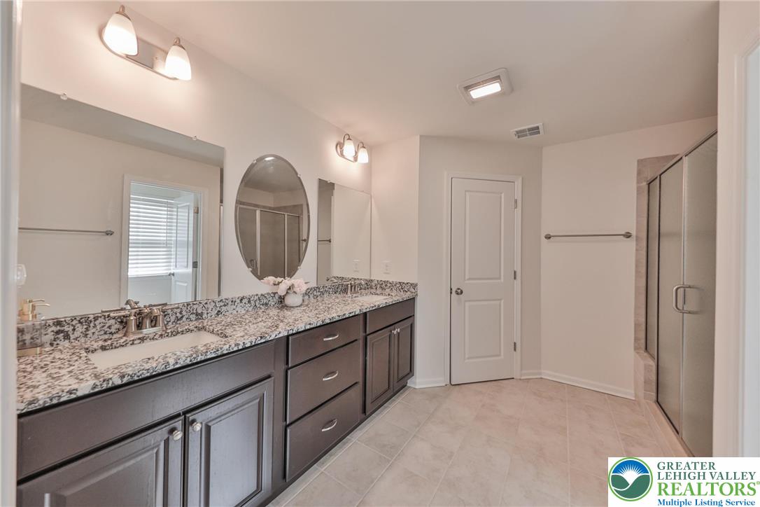 338 Abby Road Macungie, PA 18062 - Photo 34 of 40 a bathroom with a granite countertop sink and a mirror