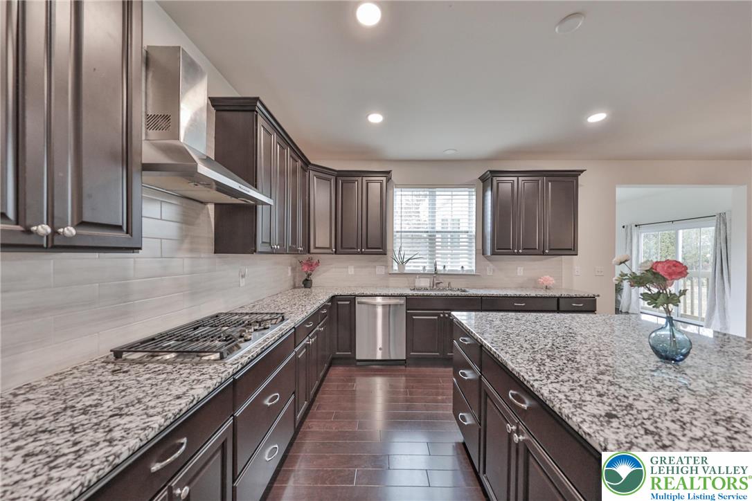 338 Abby Road Macungie, PA 18062 - Photo 9 of 40 a kitchen with stainless steel appliances granite countertop a sink and stove