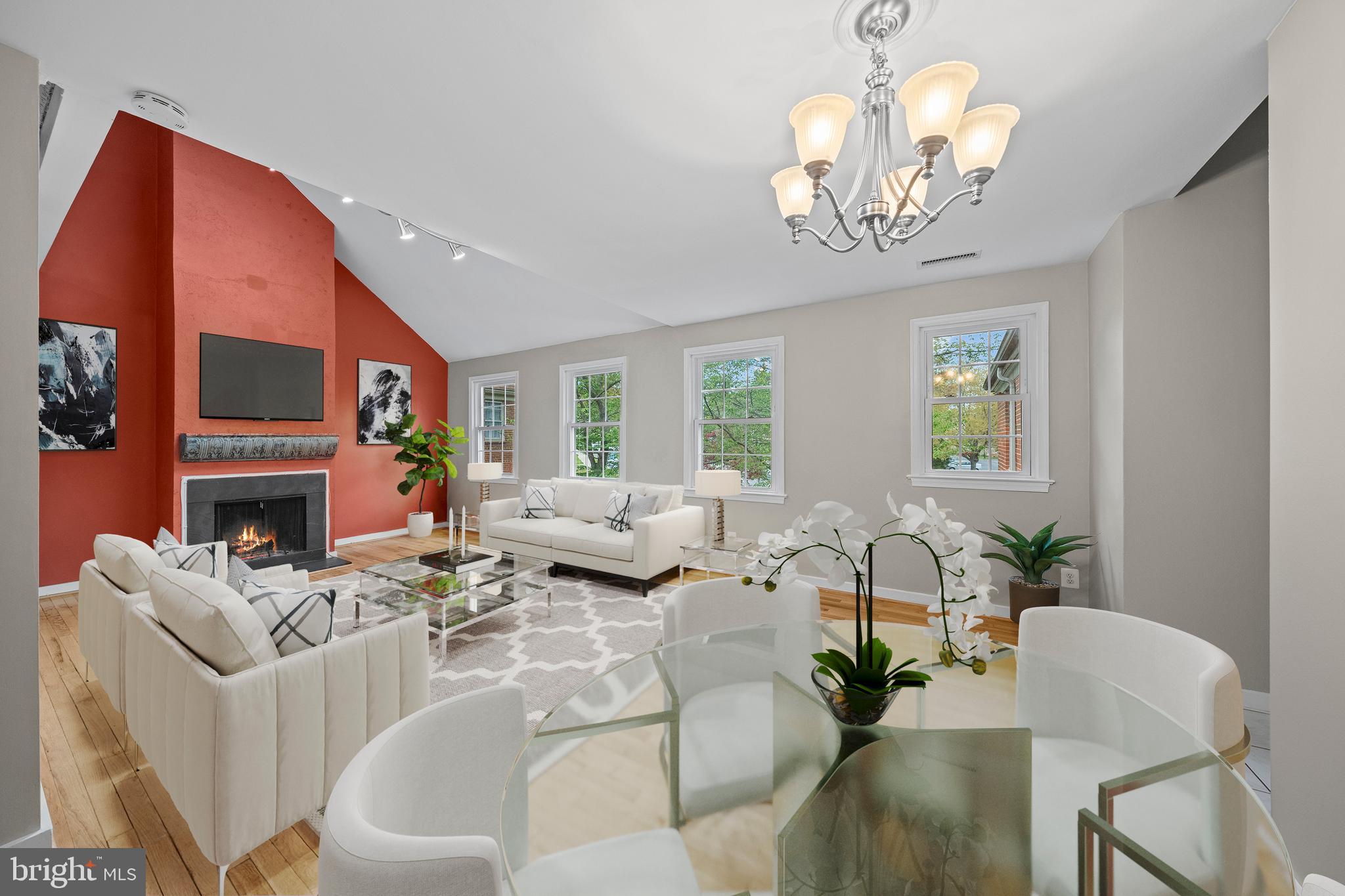 a living room with fireplace furniture and a large window