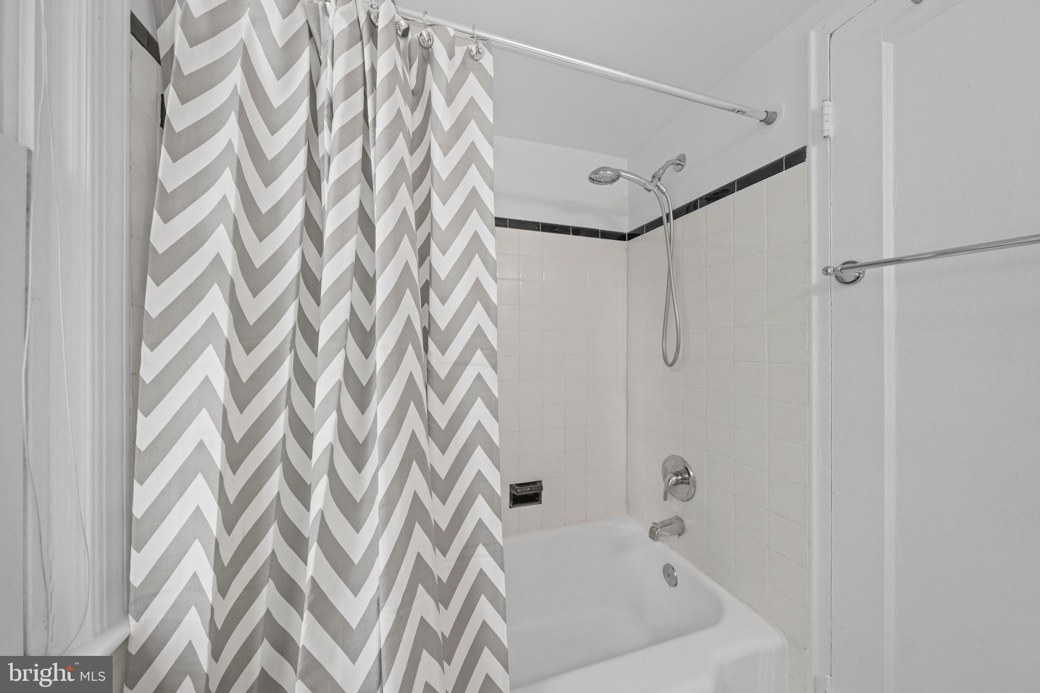 2214 Washington Avenue, Unit 204 Silver Spring, MD 20910 - Photo 12 of 32 a bathroom with a bathtub and a shower