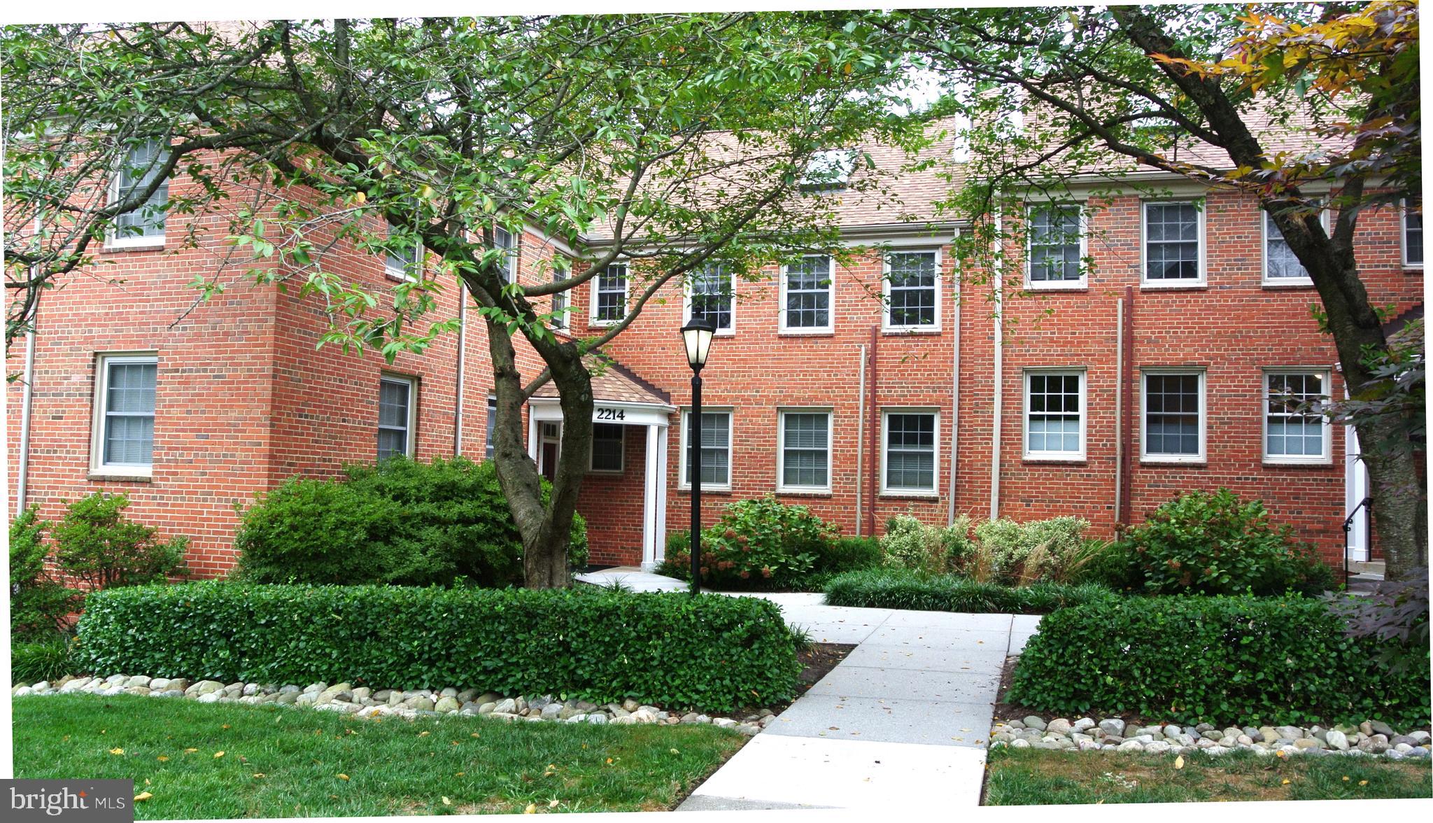 2214 Washington Avenue, Unit 204 Silver Spring, MD 20910 - Photo 2 of 32 a front view of a house with garden and trees
