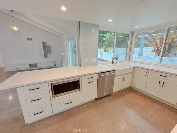 a kitchen with a sink stove and cabinets