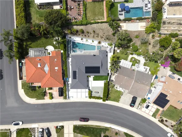 an aerial view of houses with a street