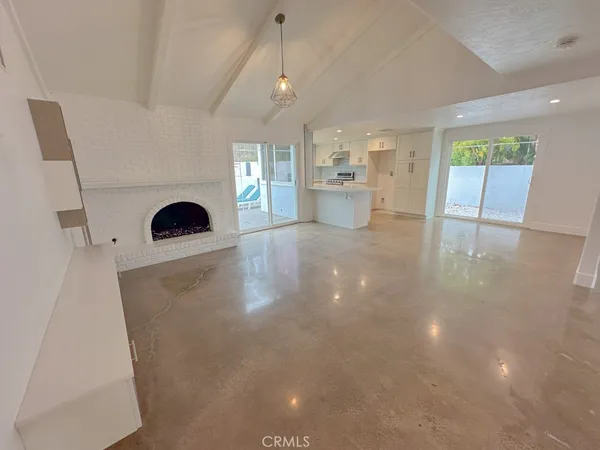 a view of a kitchen with a sink and a fireplace
