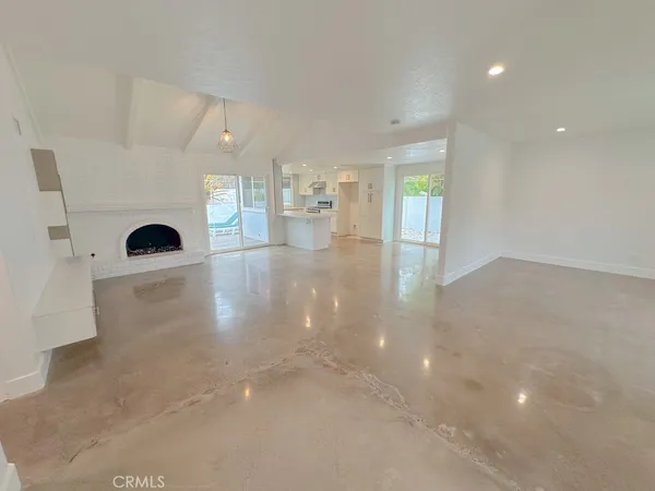 a view of a living room with fireplace and wooden floor