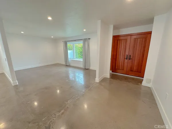 an empty room with windows and closet