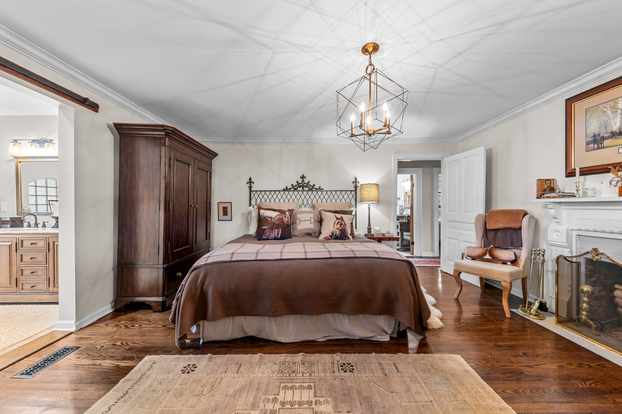 3580 Blue Creek Road Lynnville, TN 38472 - Photo 36 of 90 a bedroom with a bed a chandelier and flat screen tv