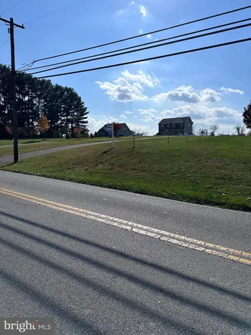 a view of a field of grass and trees