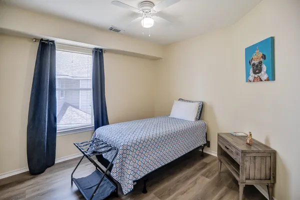 a bedroom with a bed and wooden floor