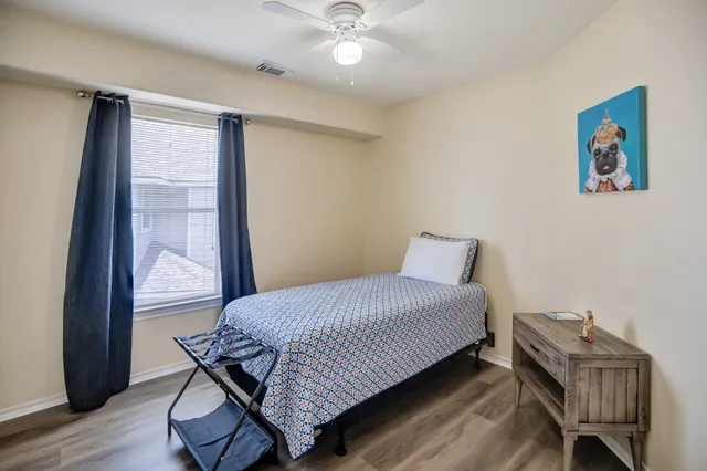 a bedroom with a bed and wooden floor