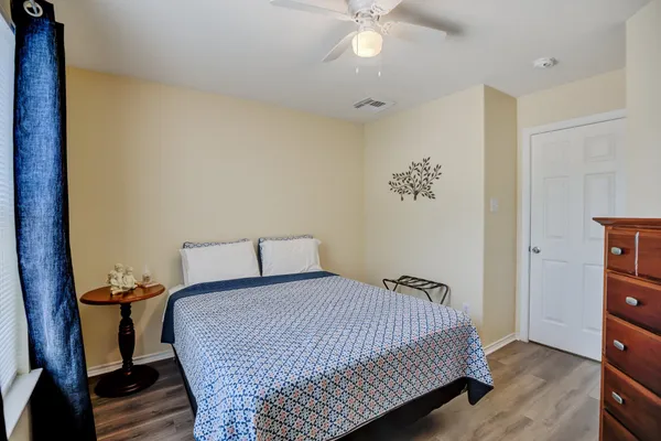 a bedroom with a bed and wooden floor