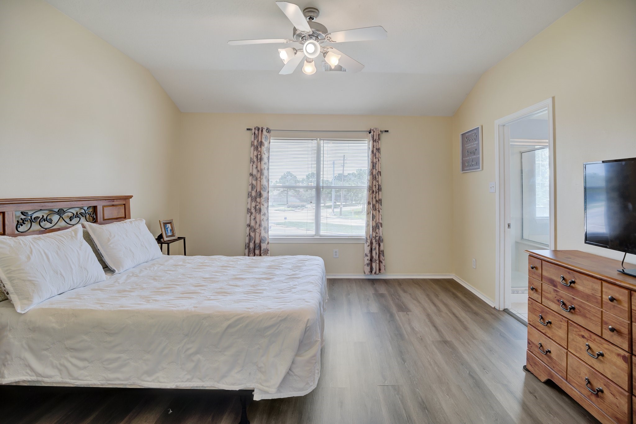 13011 Peppergate Lane Houston, TX 77044 - Photo 16 of 22 a bedroom with a bed and a flat screen tv