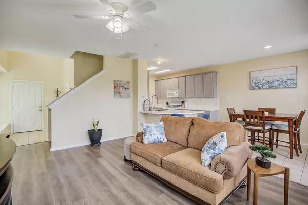 a living room with furniture and kitchen view