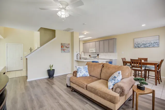 a living room with furniture and kitchen view