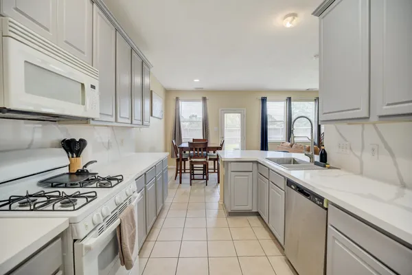 a kitchen with a sink stove and cabinets