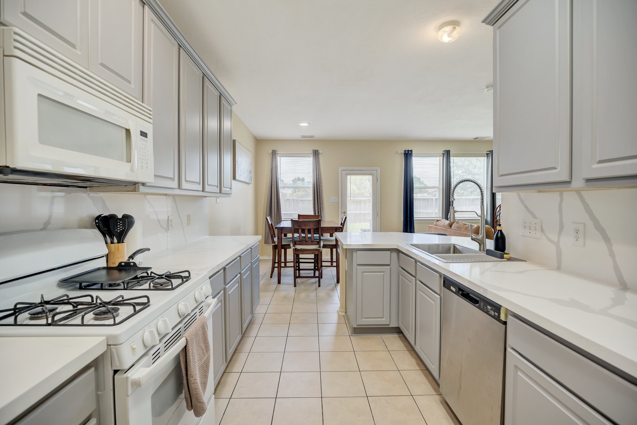 13011 Peppergate Lane Houston, TX 77044 - Photo 4 of 22 a kitchen with a sink stove and cabinets