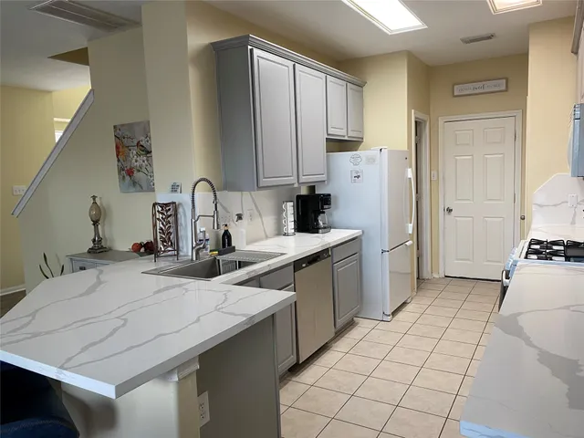 a kitchen with a sink appliances and cabinets