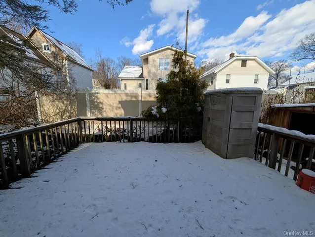 a view of a house with a wooden fence