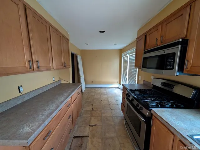 a kitchen with granite countertop a stove and a sink