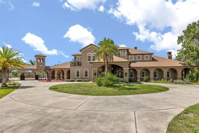 a front view of a house with a yard and trees