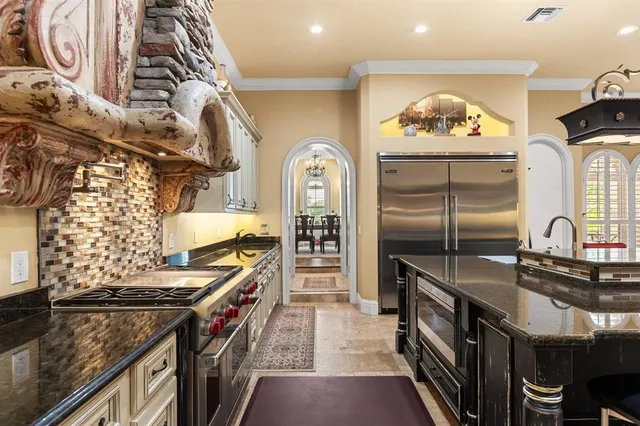 a kitchen with stainless steel appliances granite countertop a stove and a sink