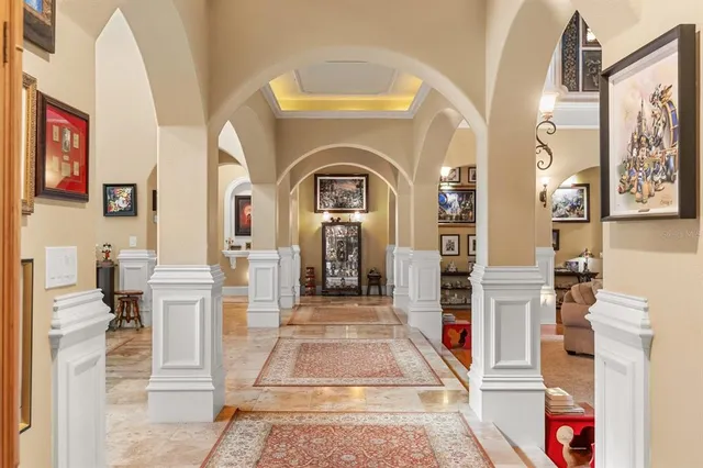 a view of a hallway with furniture and chandelier