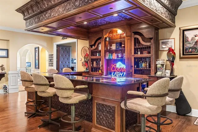 a living room with fireplace furniture and a rug