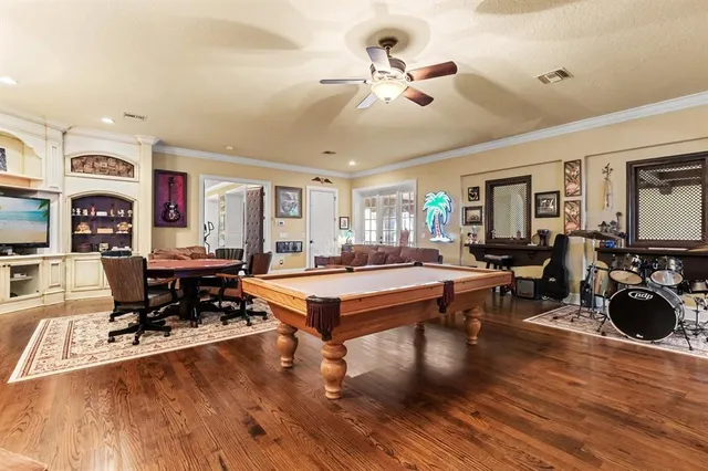 a view of living room filled with furniture and large windows