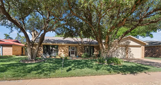 front view of a house with a tree