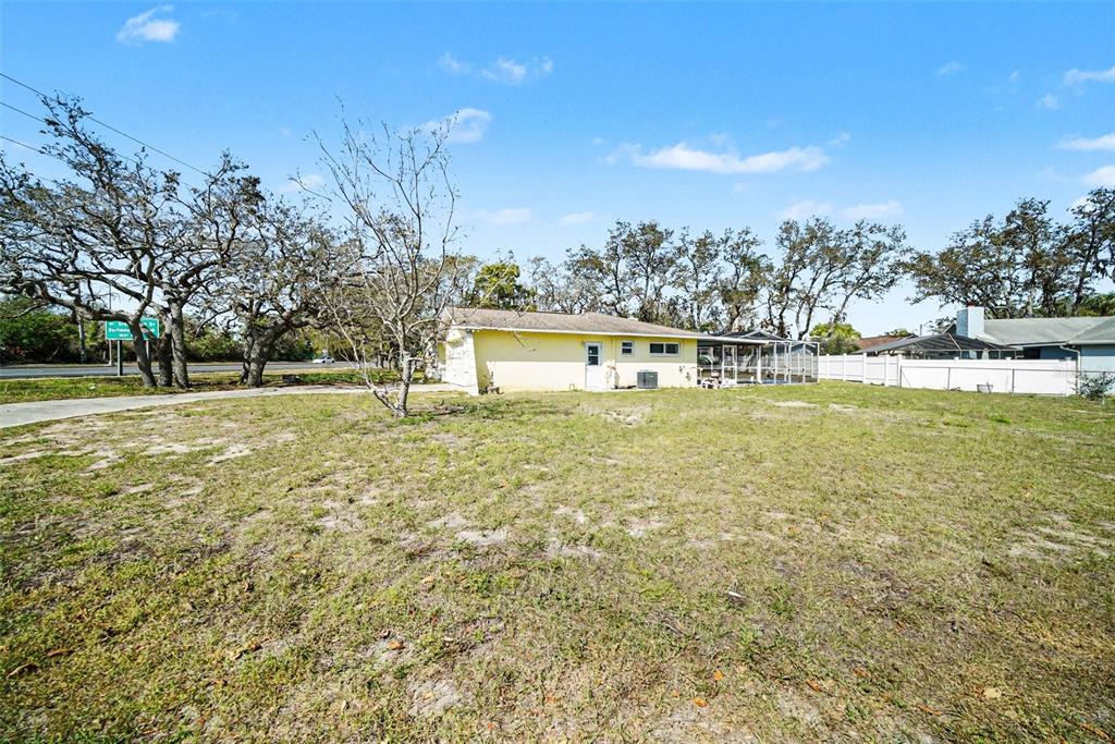 113 Ruskin Avenue Spring Hill, FL 34606 - Photo 31 of 32 a swimming pool with outdoor seating and yard