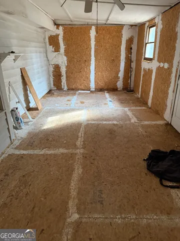 a view of a garage with wooden fence