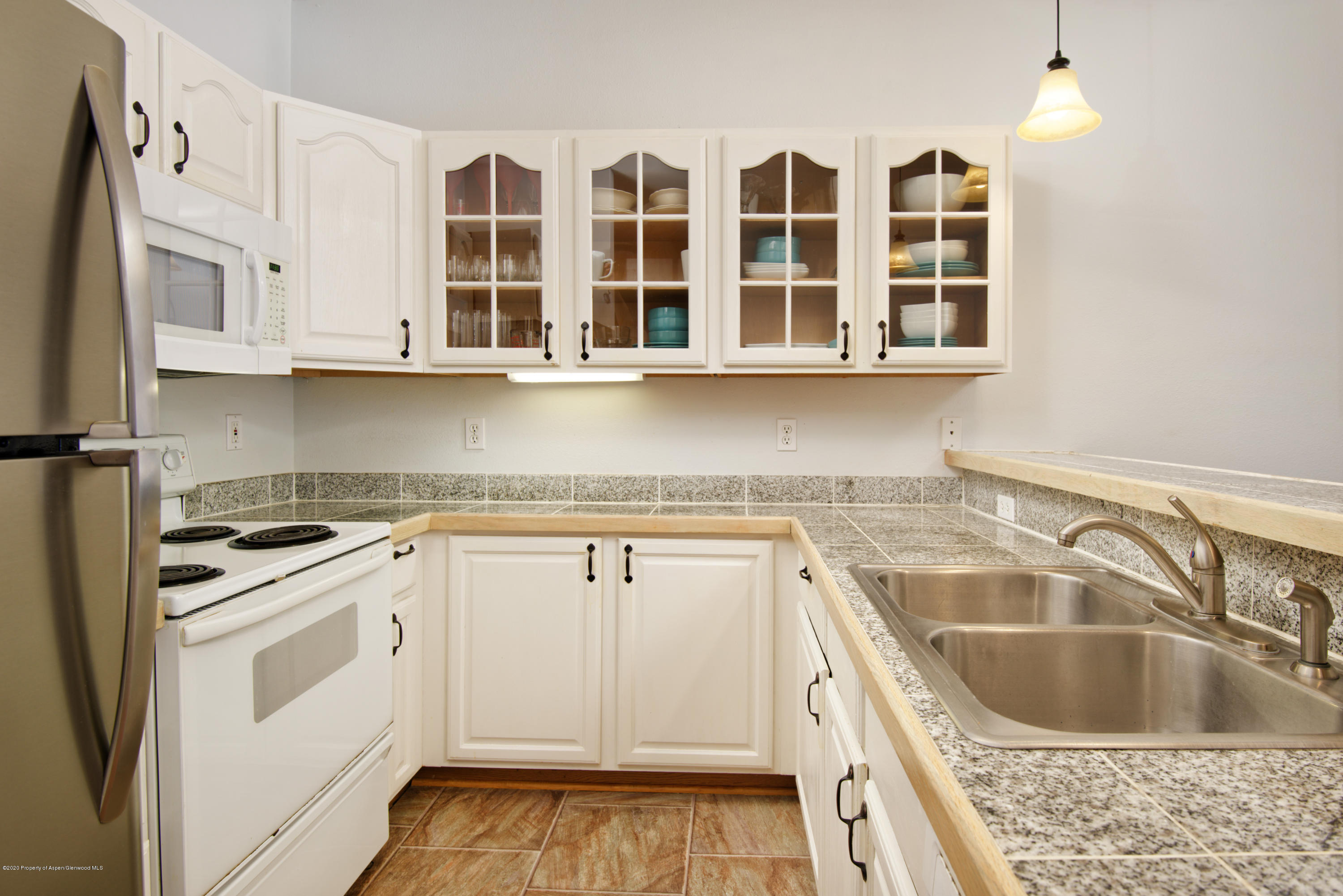 1400 East Valley Road, Unit 110 Basalt, CO 81621 - Photo 3 of 10 a kitchen with stainless steel appliances granite countertop a sink stove and cabinets
