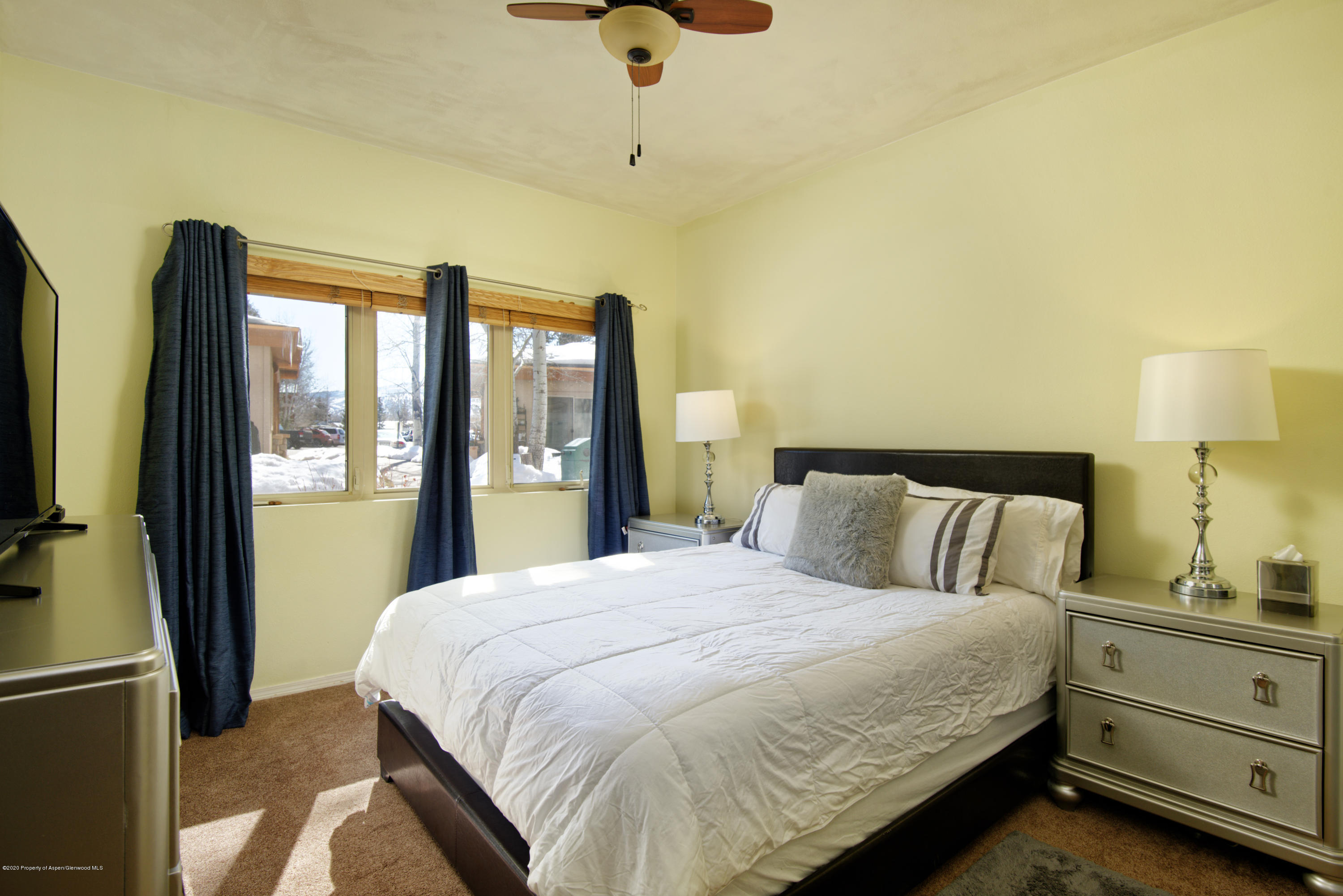 1400 East Valley Road, Unit 110 Basalt, CO 81621 - Photo 7 of 10 a bedroom with a bed and a night stand