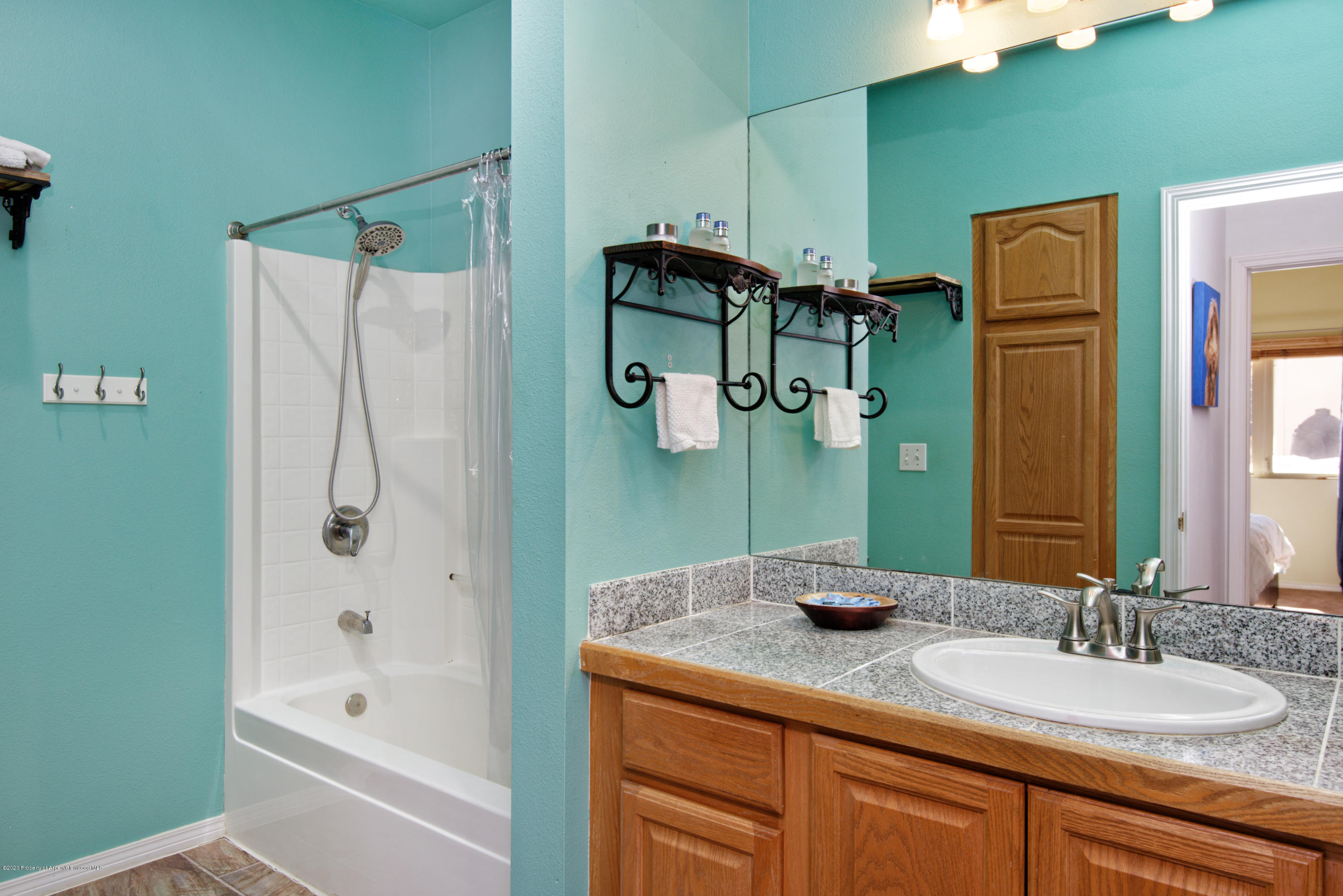 1400 East Valley Road, Unit 110 Basalt, CO 81621 - Photo 8 of 10 a bathroom with a granite countertop sink and a mirror