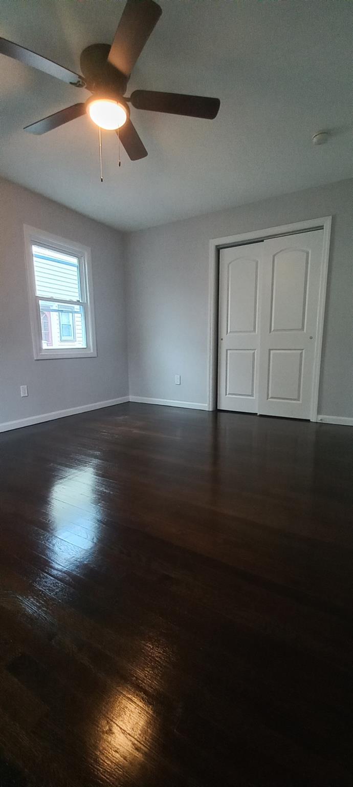 3 Hampton Road Lynbrook, NY 11563 - Photo 11 of 23 Empty room with a ceiling fan, baseboards, and dark wood finished floors